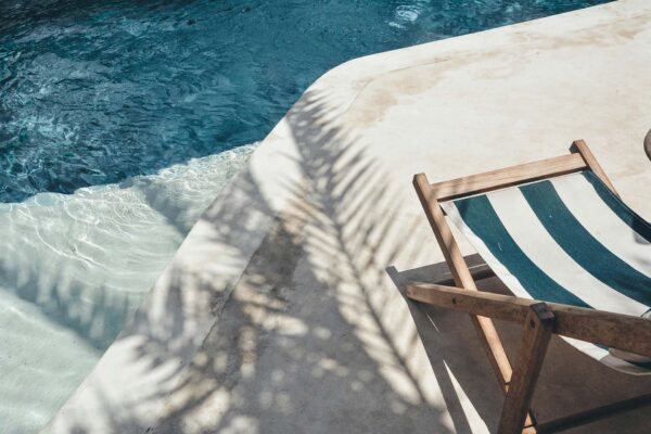 Pool with striped lounge chairs.